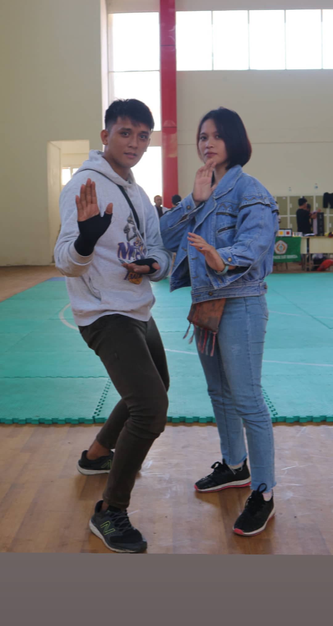 Brenda and Marck striking a playful martial arts pose