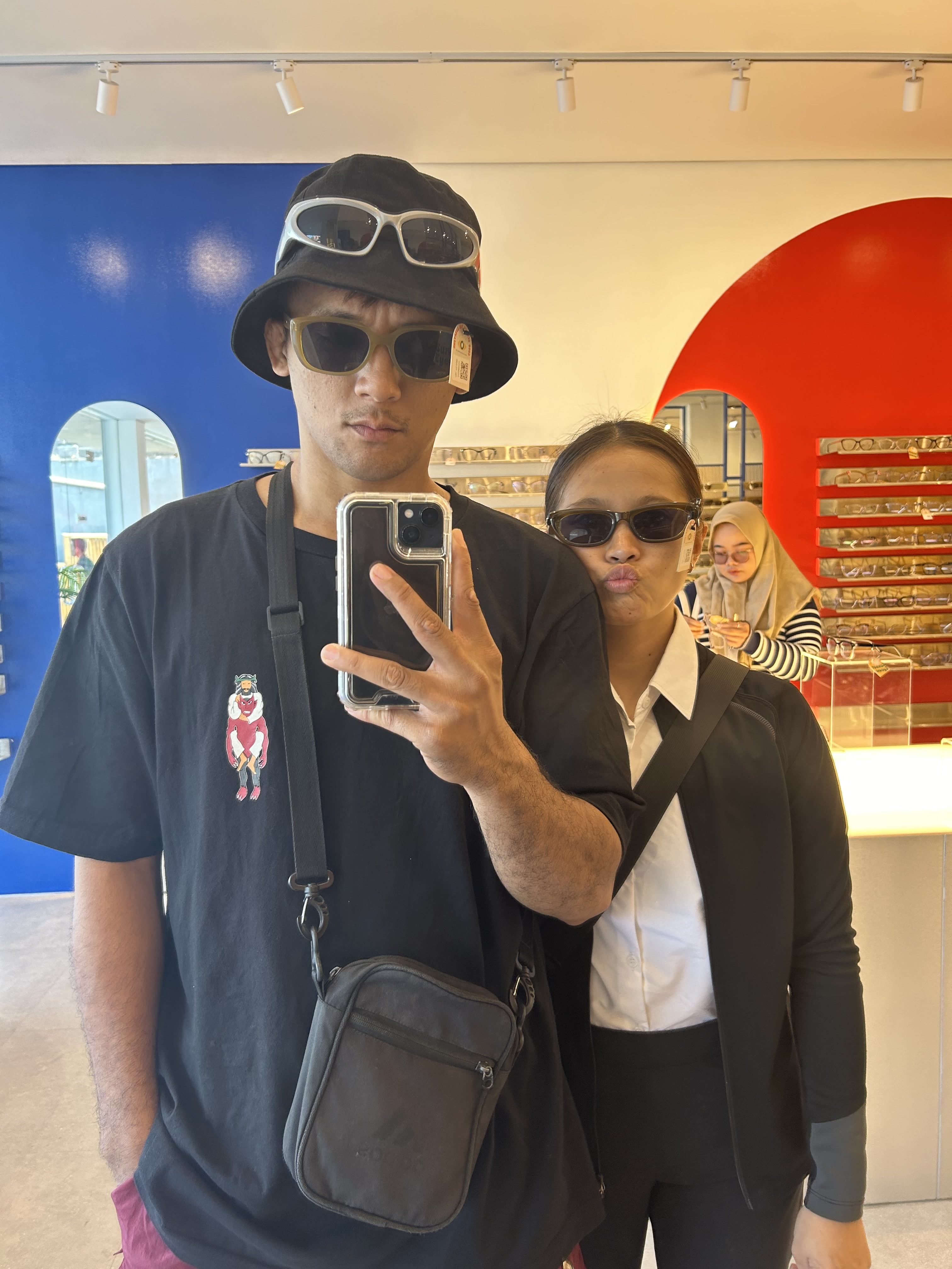 Brenda and Marck trying on sunglasses together