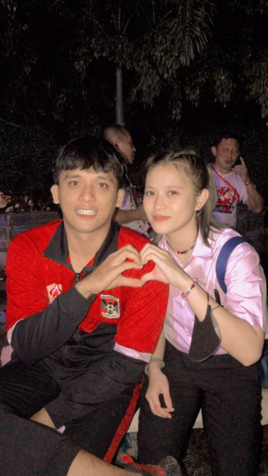 Brenda and Marck making a heart with their hands
